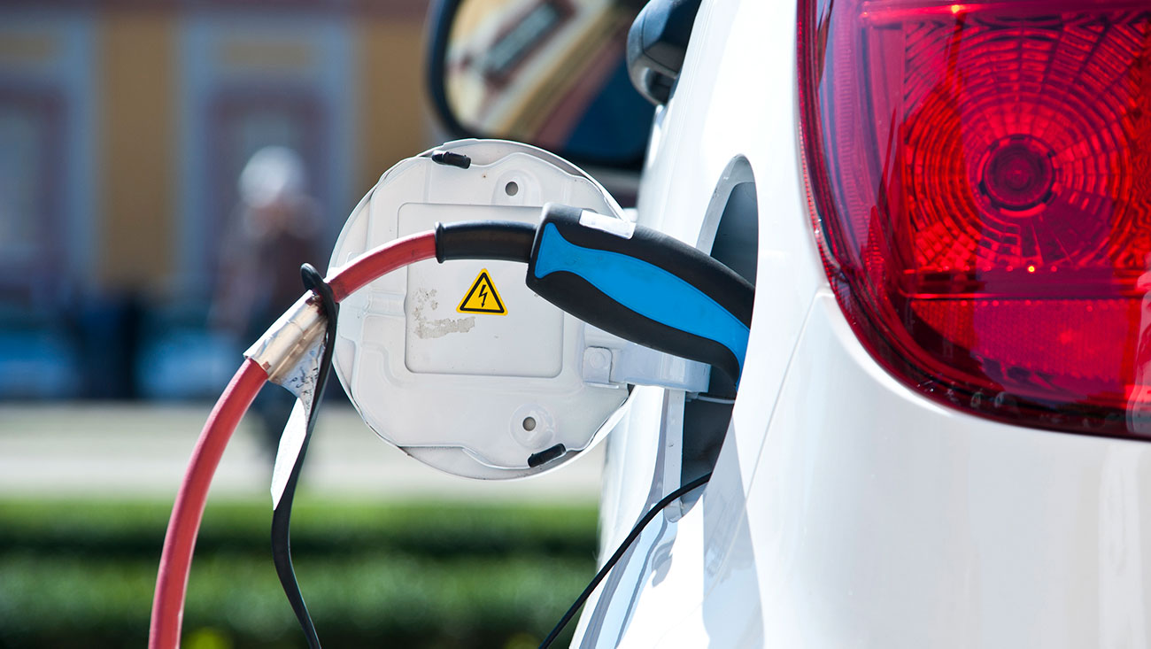 a close-up of a white car with a red light