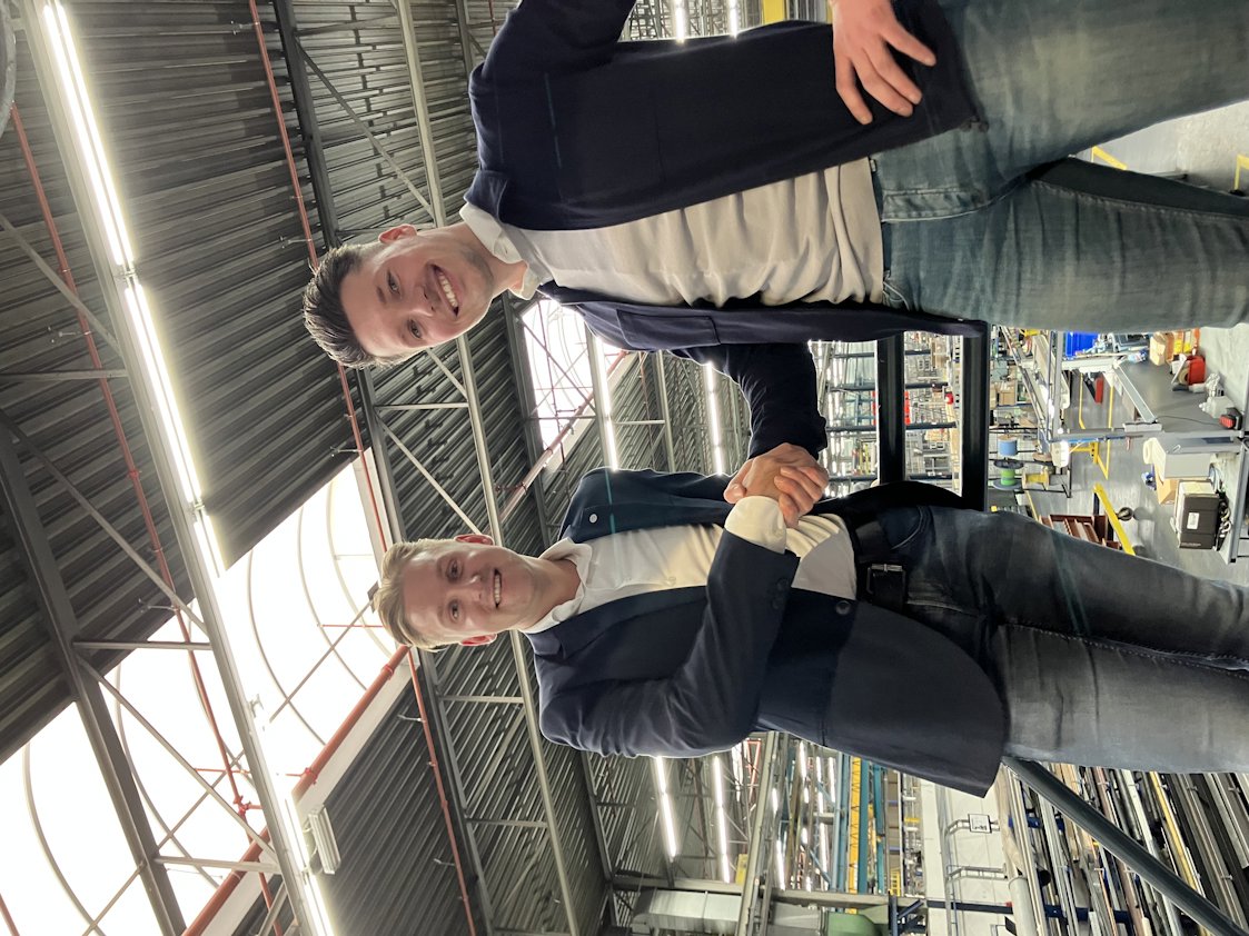 a couple of men smiling